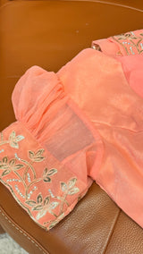 Vasundhara Fashions peach chiffon saree blouse sleeve with intricate gold floral embroidery and crystal embellishments