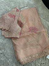 Vasundhara Fashions peach Kora saree with intricate pink floral embroidery, gold beadwork, and scalloped border edges.