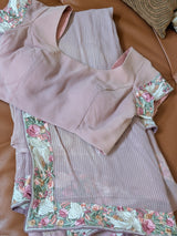Vasundhara Fashions pink chiffon saree featuring delicate floral embroidery and subtle sequin detailing on the border.