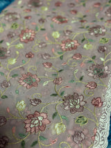 Vasundhara Fashions pink chikankari saree featuring intricate floral embroidery with green and metallic thread details