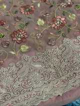 Vasundhara Fashions pink saree featuring intricate floral embroidery and detailed silver threadwork border