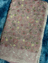 Vasundhara Fashions pink Chikankari saree featuring intricate floral embroidery and a detailed lace border.