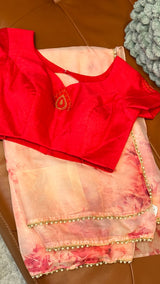 Vasundhara Fashions pink floral organza saree paired with a vibrant red blouse featuring intricate beadwork