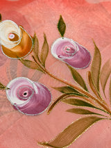 Vasundhara Fashions pink organza saree featuring delicate hand-painted floral motifs with silver and gold embroidery.