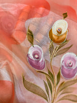Vasundhara Fashions pinkish organza saree featuring delicate hand-painted floral rose motifs with gold accents.