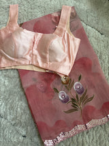 Vasundhara Fashions pink organza saree with hand-painted floral motifs and mirror work border, paired with satin blouse