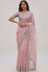 Vasundhara Fashions pink organza saree with intricate silver embroidery and a matching ruffled sleeve blouse