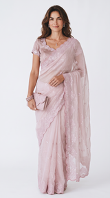 Vasundhara Fashions light pink organza saree with delicate sequin embroidery and matching blouse on a woman