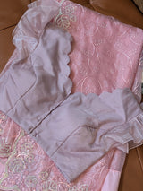 Vasundhara Fashions pink organza saree with floral embroidery and a matching scalloped edge blouse