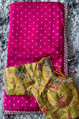 Vasundhara Fashions pink pearl embellished saree paired with a contrast yellow patterned stitched blouse