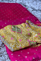 Vasundhara Fashions pink pearl embellished saree paired with a yellow contrast blouse featuring intricate embroidery.