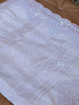 Vasundhara Fashions light pink and purple organza saree featuring intricate scalloped edges and shimmering sequins