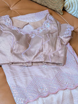 Vasundhara Fashions light pink and purple organza saree with intricate sequin embroidery and scalloped edges.