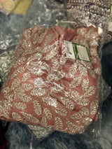 Vasundhara Fashions dusty pink drape saree featuring intricate silver sequin leaf embroidery in plastic packaging.