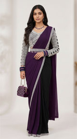 Vasundhara Fashions purple and black pleated drape saree with a geometric print blouse and matching embellished bag.