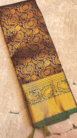 Vasundhara Fashions purple and gold mix pattu silk saree featuring intricate floral zari work and a wide border.