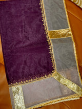 Vasundhara Fashions Kora embroidery saree in deep purple and sheer grey fabric with intricate gold border detailing.