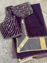 Vasundhara Fashions deep purple Kora saree with intricate silver embroidery and gold border detailing on the blouse.