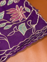 Vasundhara Fashions purple Kora saree featuring intricate floral embroidery with gold thread and sage green accents.