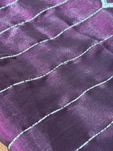 Vasundhara Fashions purple organza saree with shimmering horizontal silver beadwork lines and a scalloped border.