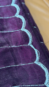 Vasundhara Fashions purple organza saree featuring horizontal silver lines and a scalloped border with beadwork.