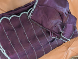 Vasundhara Fashions purple organza saree with silver horizontal lines and a scalloped beaded border on leather surface