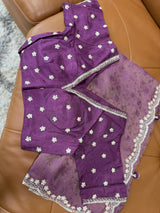 Vasundhara Fashions purple organza saree with self-print patterns and matching blouse featuring floral embroidery
