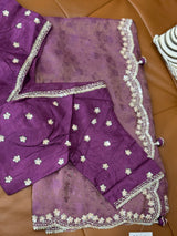 Vasundhara Fashions purple organza saree with self-print, floral sequin embroidery, and scalloped border detailing.