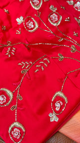 Vasundhara Fashions red organza saree featuring intricate gold thread embroidery and floral sequin embellishments