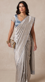 Vasundhara Fashions silver Kanchipuram pattu silk saree with intricate zari work worn by a model with a matching clutch