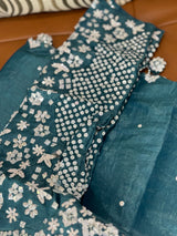 Vasundhara Fashions teal Russian silk saree featuring intricate silver sequin and mirror work embroidery on the blouse