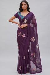 Model wearing a Vasundhara Fashions wine chiffon saree with floral sequin embroidery and a matching sequin blouse