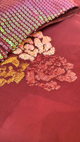 Vasundhara Fashions wine chiffon saree featuring intricate floral sequin embroidery and a matching sequin blouse.